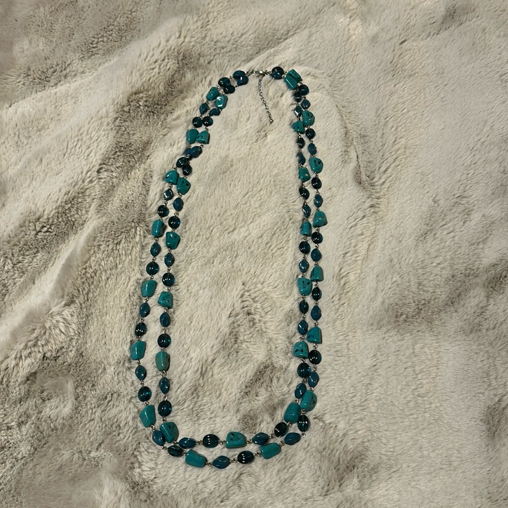 Like new double stranded necklace with turquoise colored stones.